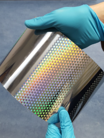 The image shows a printing cylinder decorated with laser-etched micro- and nanometer-scale structures.