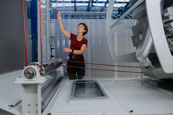 Technische Mitarbeiterin an der Rolle-zu-Rolle Anlage zur Fertigung von transparenten flexiblen Verkapselungsfolien für Dünnschichtphotovoltaik. Foto: Erik Kazak Technische Mitarbeiterin an der Rolle-zu-Rolle Anlage zur Fertigung von transparenten flexiblen Verkapselungsfolien für Dünnschichtphotovoltaik.